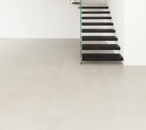 Houston Room with stair case and tile floor with matching grout color